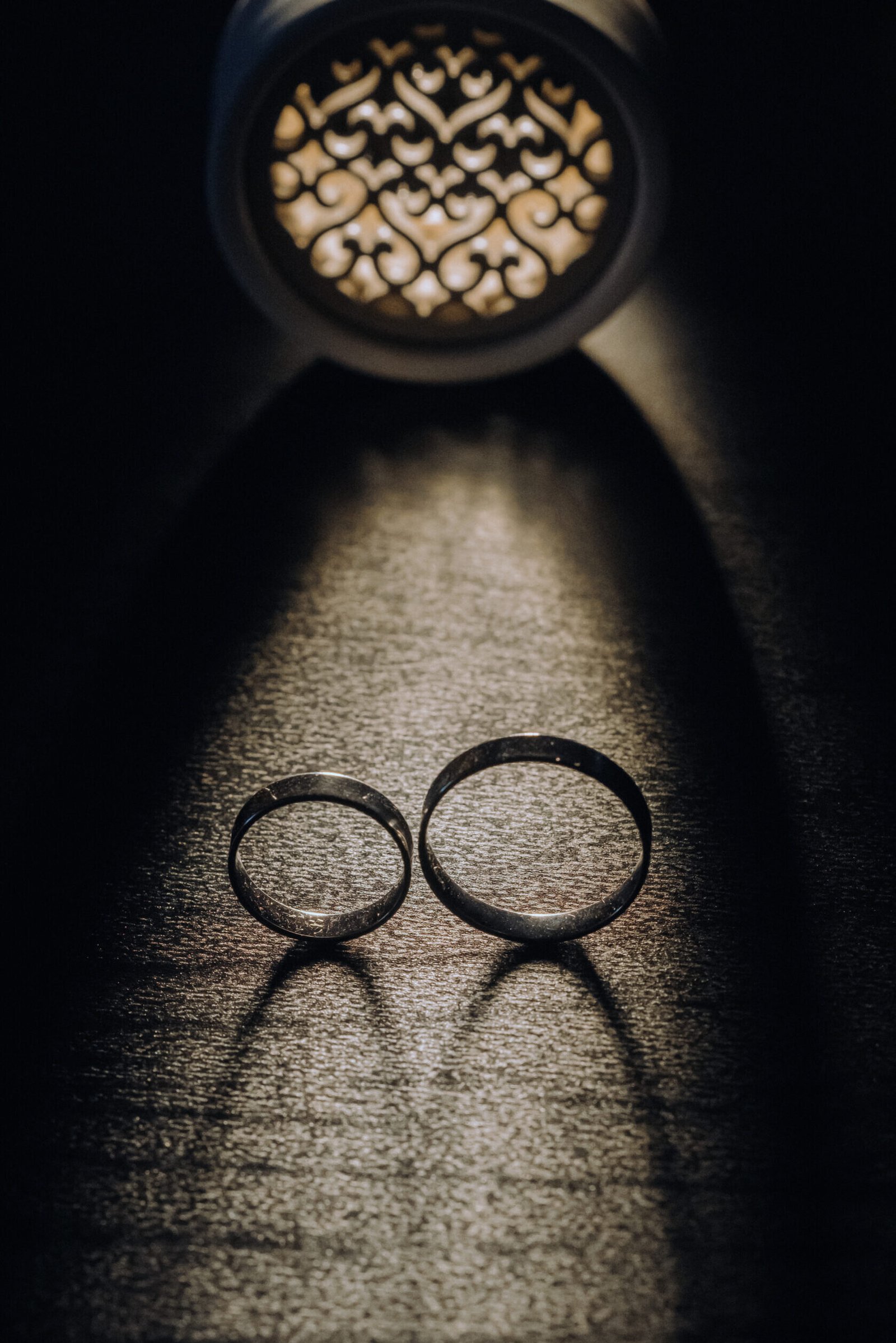 Home close up of two gold wedding rings on a black background